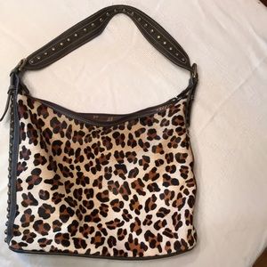 Leather handbag with studs and real hair.